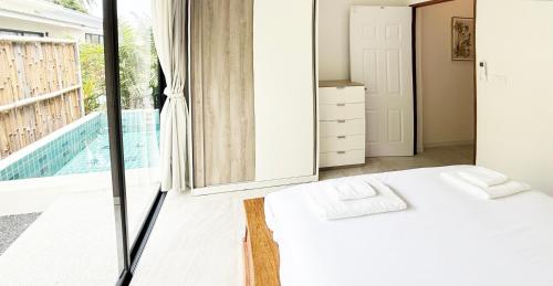 a bedroom with a large mirror and a bed at Sri Thanu Escape 2 in Srithanu