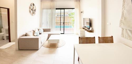 a living room with a couch and a table at Sri Thanu Escape 2 in Srithanu