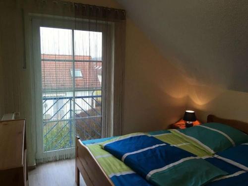 a bedroom with a bed and a large window at Holiday Park Lenzer Höh VI in Lenz