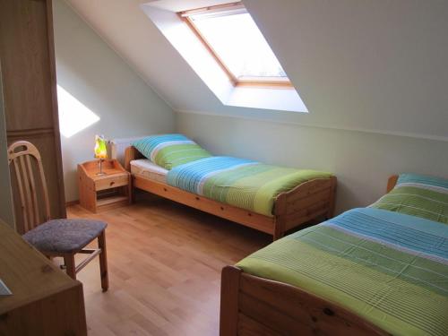 a attic bedroom with two beds and a skylight at in the Lenzer Höh I holiday park in Lenz