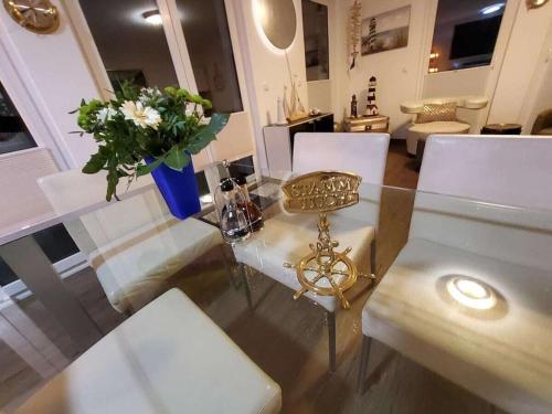 a dining room with a glass table and white chairs at Holiday apartment with 2 bedrooms in Sassnitz