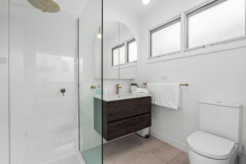 a bathroom with a shower and a toilet and a sink at Mrs Issy in Queenscliff