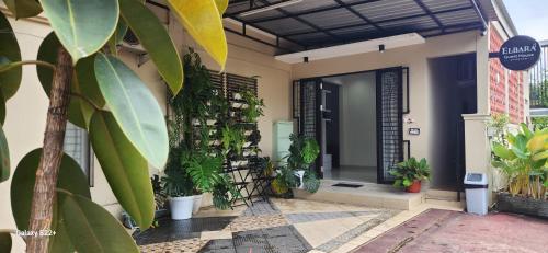 a house with plants on the side of it at Elbara Guest House Syariah in Banjarbaru