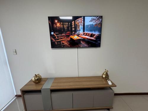 a tv hanging on a wall in a room at Beautiful Family Apartment with Pool WiFi Central Team in Santa Cruz de la Sierra