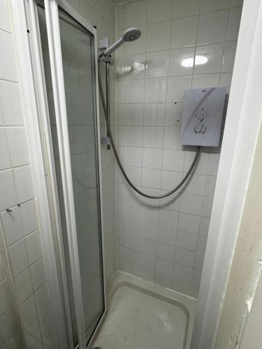 a shower in a bathroom with a glass door at Reads Avenue 1 Bed Apartment - Next To H&A Social Club - Minutes from Winter Gardens & Town Centre! in Blackpool