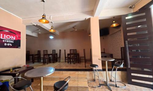 a restaurant with tables and chairs in a room at San Villa Hotel & Restaurant in Maharagama