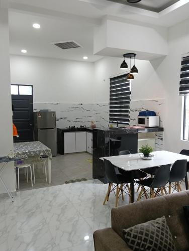 a kitchen and dining room with a table and chairs at Hannan Homestay Kuala Terengganu in Kuala Terengganu