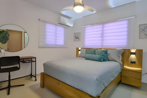 a bedroom with a bed and a desk and a chair at Sunset Brightness in a 1Bdrm Apt. in Punta Cana in Punta Cana