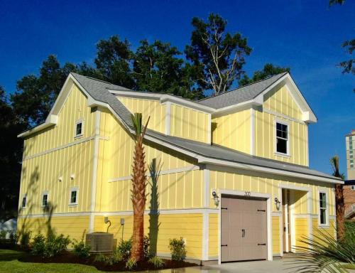 a yellow house with a gray roof at Spacious House near the Beach 300 in Myrtle Beach