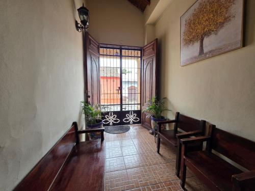 a hallway with benches and a window in a building at Hotel Casona Macondo, Granada, Nicaragua in Granada