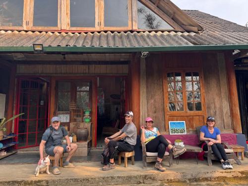 a group of people sitting in front of a house at De Yang House Sa Pa in Sapa