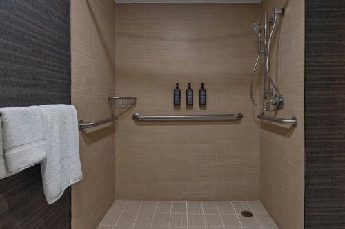 a bathroom with a shower with white towels at Sheraton Albuquerque Airport Hotel in Albuquerque