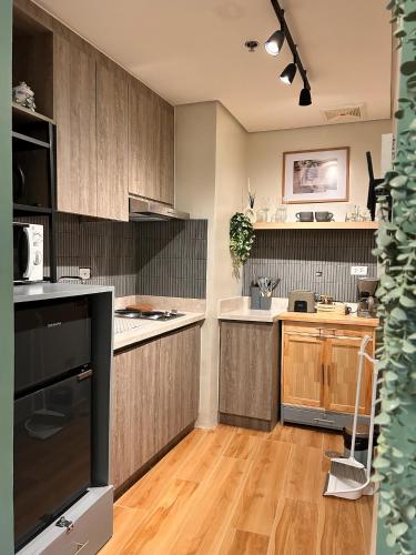 a kitchen with wooden cabinets and a counter top at Suite Hugs in Laurel