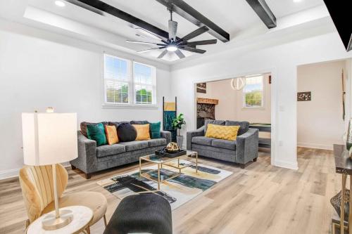 a living room with couches and a ceiling fan at The EleMEnt in Goldsboro