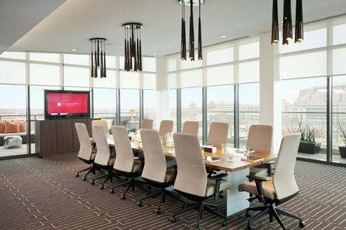 a conference room with a long table and chairs at The Alexander in Indianapolis