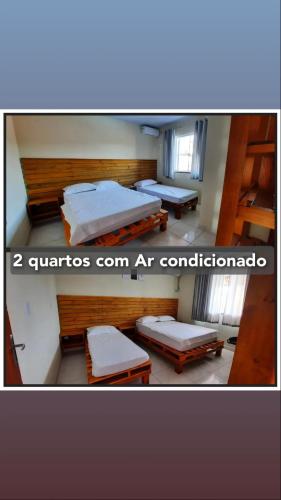 a room with two beds in a room at Seven76Residence in Barra Velha