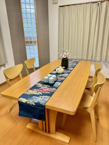a wooden dining room table with chairs and a blue table runner at 夏様香驛 Spacious Traditional Kyoto House, 4 Bedrooms, Sleeps 8, 2 Bathrooms in Kyoto