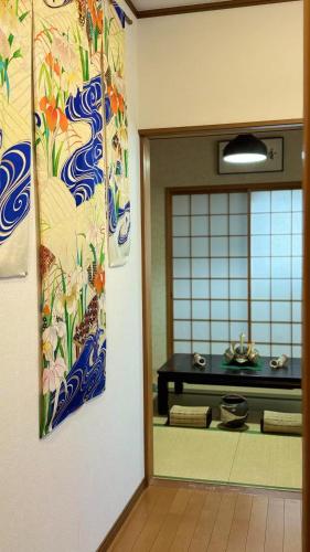 a door to a room with a painting on the wall at 夏様香驛 Spacious Traditional Kyoto House, 4 Bedrooms, Sleeps 8, 2 Bathrooms in Kyoto