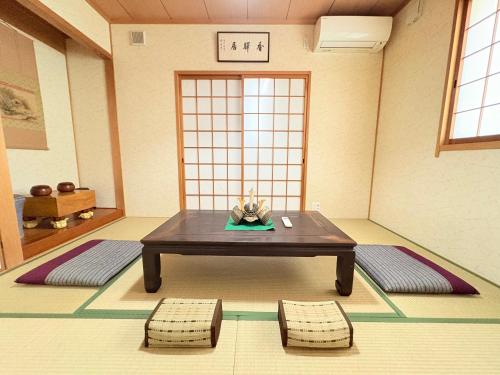 a room with a table and two chairs in it at 夏様香驛 Historic Kyoto Villa, 4LDK Private House, Perfect for Families in Kyoto