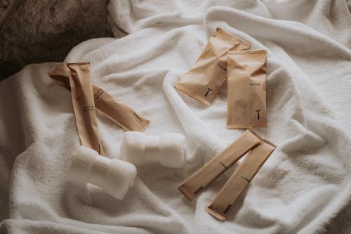 a white blanket with three pieces of paper on it at THE NEST NAHA in Naha
