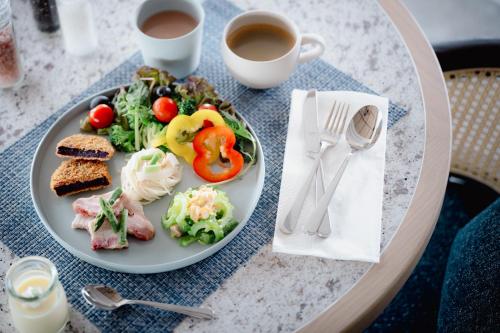 a plate of food on a table with a cup of coffee at THE NEST NAHA in Naha