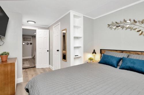 a bedroom with a large bed with blue pillows at Newly Updated Modern 1-Bedroom Private Guesthouse in Clearwater