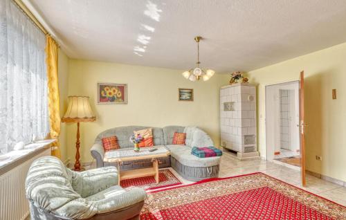 a living room with a couch and two chairs at Ferienwohnung Wesenberg in Strasen