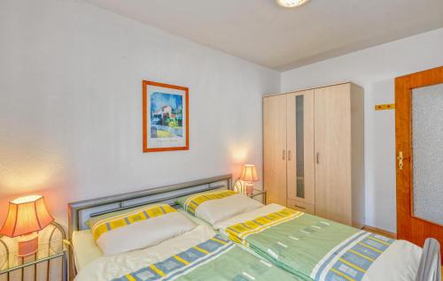 a bedroom with two beds and two lamps in it at Ferienwohnung Wesenberg in Strasen
