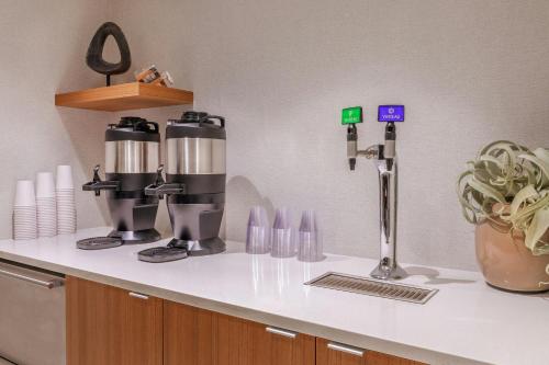 a kitchen counter with a coffee maker on it at SpringHill Suites Denver North / Westminster in Westminster