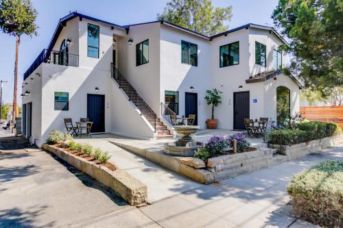 a white house with a staircase and a fountain at Casa Valerio - Boutique Suites in Downtown Santa Barbara in Santa Barbara