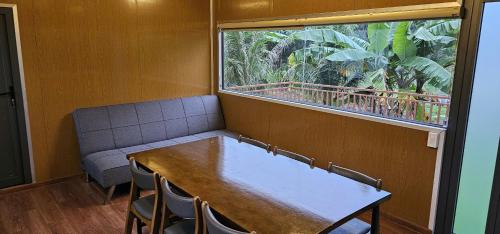 a room with a table and chairs and a window at Lakeside Đá Bàng Ecolodge, ấp Tân Hiệp, xã Long Tân, Huyện Đất Đỏ, BRVT in La Sơn
