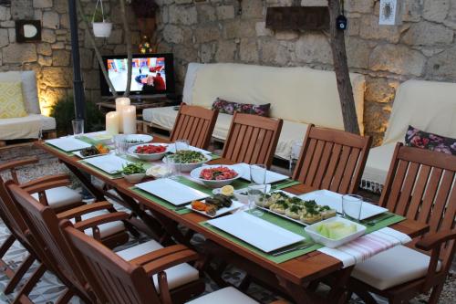 a table with dishes of food on it at Lilyum Alaçatı - Taş Ev in Alacati