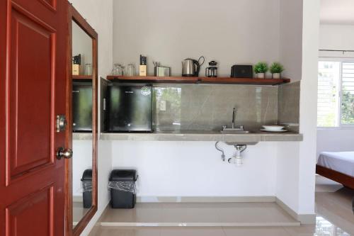 a bathroom with a sink in a room at Apartamento 22 in Bacalar