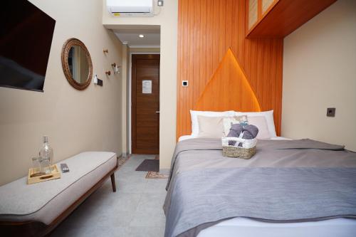 a hotel room with two beds and a mirror at Casa de Java Jogja in Kejayan