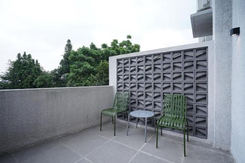 two chairs and a table on a patio at Casa de Java Jogja in Kejayan