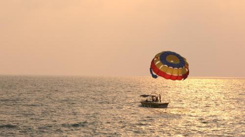 a kite flying over a boat in the ocean at ibis Styles Goa Calangute - An Accor Brand in Calangute