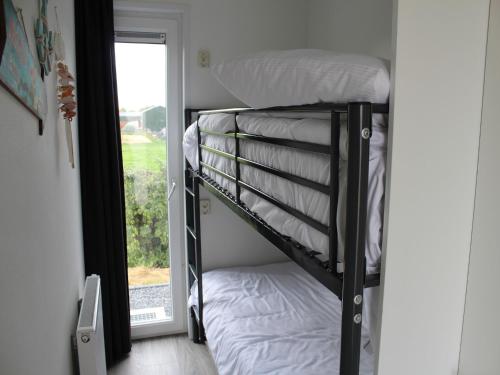 a couple of bunk beds in a room with a window at Charming Retreat for Your Escape in Bemelen