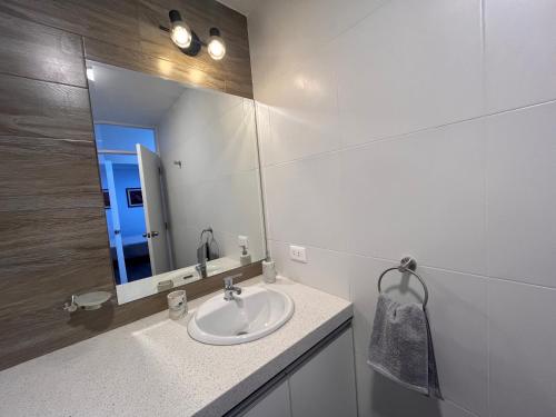 a bathroom with a sink and a mirror at Departamento estreno Yanahuara in Arequipa