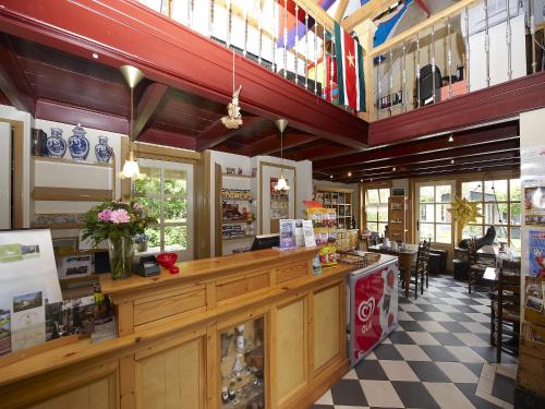 HippolytushoefにあるChalet in Wiringherlant with Garden Terraceのカウンターとテーブルと椅子のあるレストラン