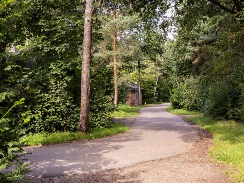 a dirt road in the middle of a forest at Cozy Forest Retreat Near Putten in Putten