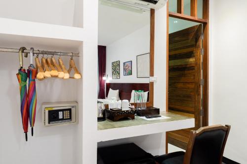 a room with a desk and a mirror and a room at Green View Village Resort in Ao Nang Beach