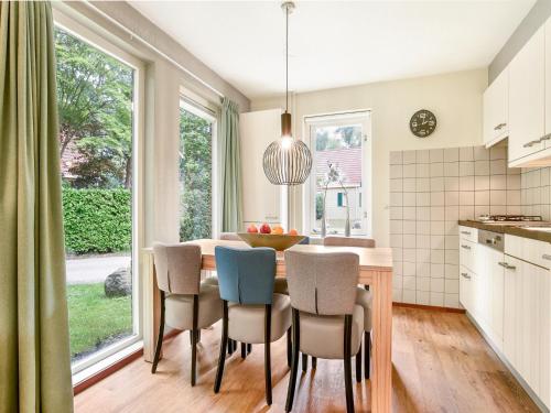 a kitchen and dining room with a table and chairs at Holiday Home in Diessen near Tilburg 