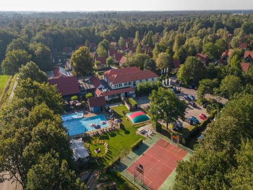 an aerial view of a resort with a pool and a park at Holiday Home in Diessen near Tilburg 