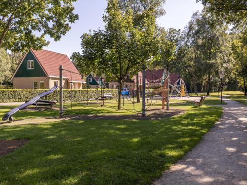 a park with a slide and a playground at Holiday Home in Diessen near Tilburg 
