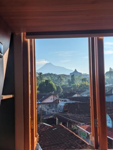 an open window with a view of a city at Casa de Java Jogja in Kejayan