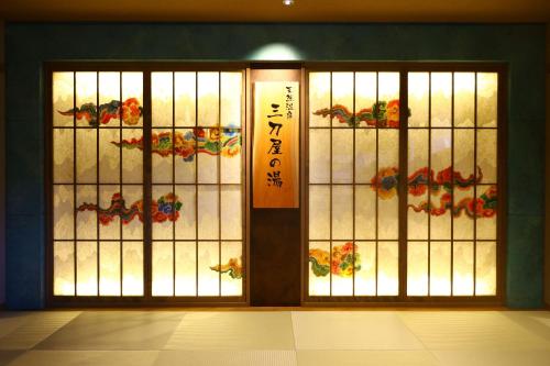 an entrance to a building with a door with a window at Dormy Inn Express Unnan Natural Hot Spring in Satogata