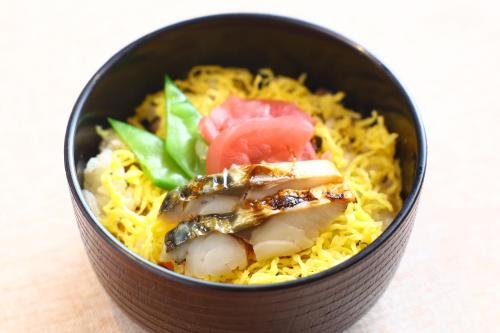 a black bowl of food with shrimp and vegetables at Dormy Inn Express Unnan Natural Hot Spring in Satogata