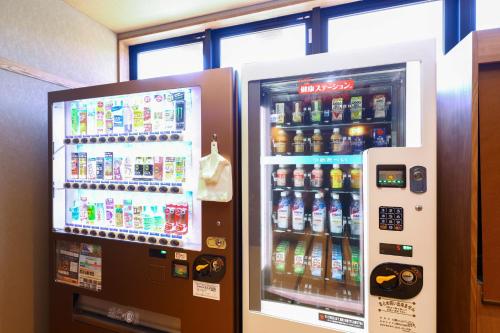 two vending machines with soda and sodas at Dormy Inn Express Unnan Natural Hot Spring in Satogata