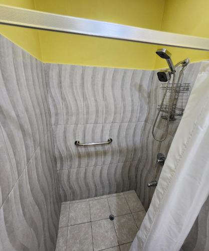a bathroom with a shower with a yellow ceiling at Carolina Point Resort in Crown Point