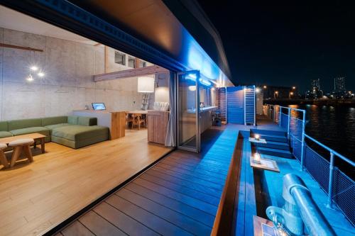 a rooftop deck with a swimming pool at night at TUGBOAT Suite in Osaka